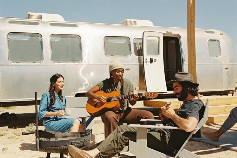 Luxury glamping tents in a desert setting with mountains in the background